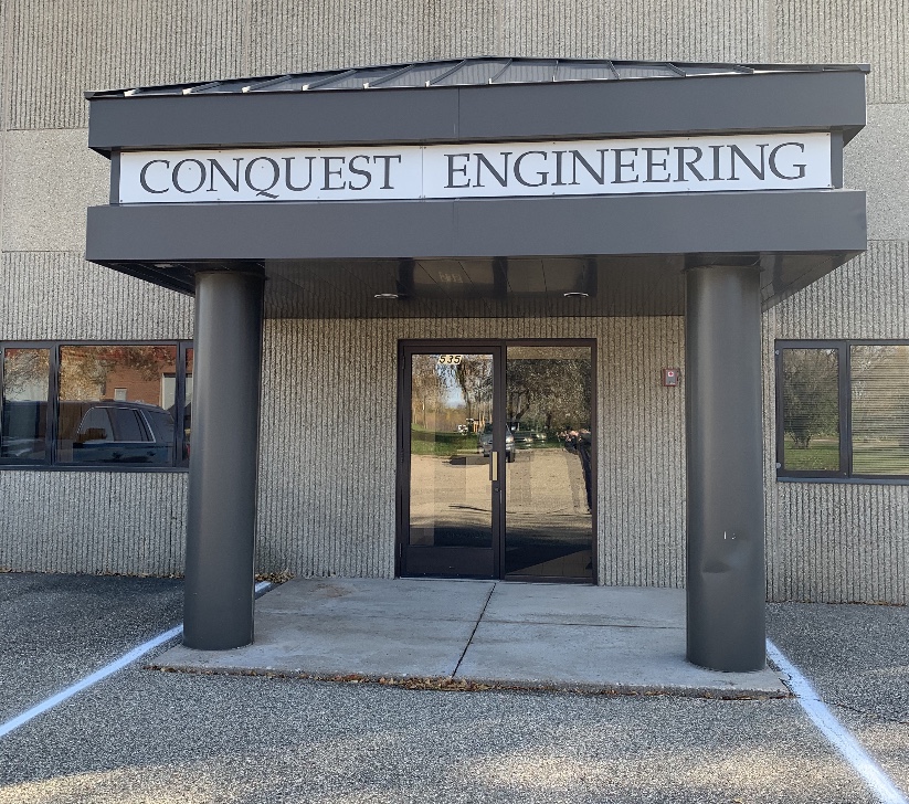 Conquest Engineering building front entrance with a sign above the door.